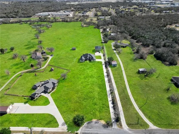 an aerial view of a golf course with parking space