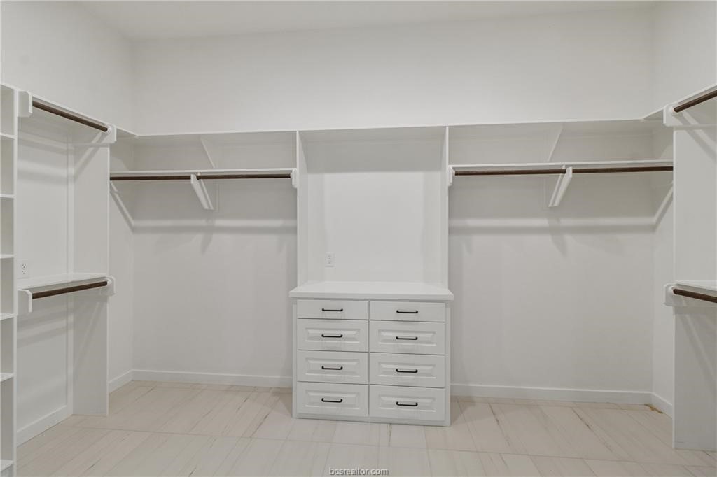 4558 Hicks Lane Bryan, TX 77845 - Photo 33 of 48 a view of walk in closet with empty racks