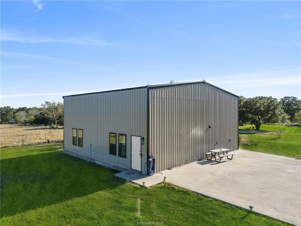 4558 Hicks Lane Bryan, TX 77845 - Photo 40 of 48 a backyard of a house with yard and lake view