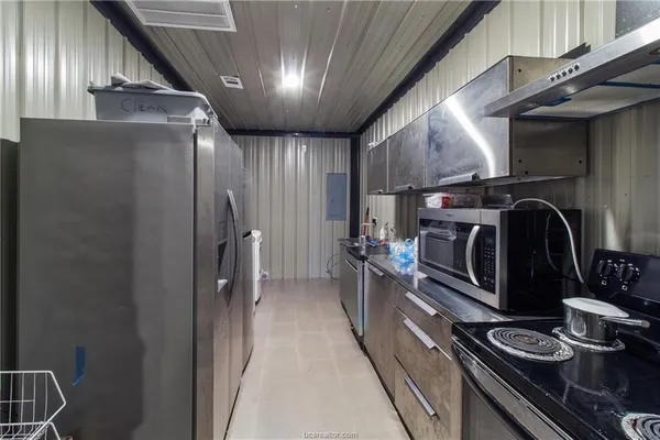 a kitchen with stainless steel appliances granite countertop a refrigerator and a stove