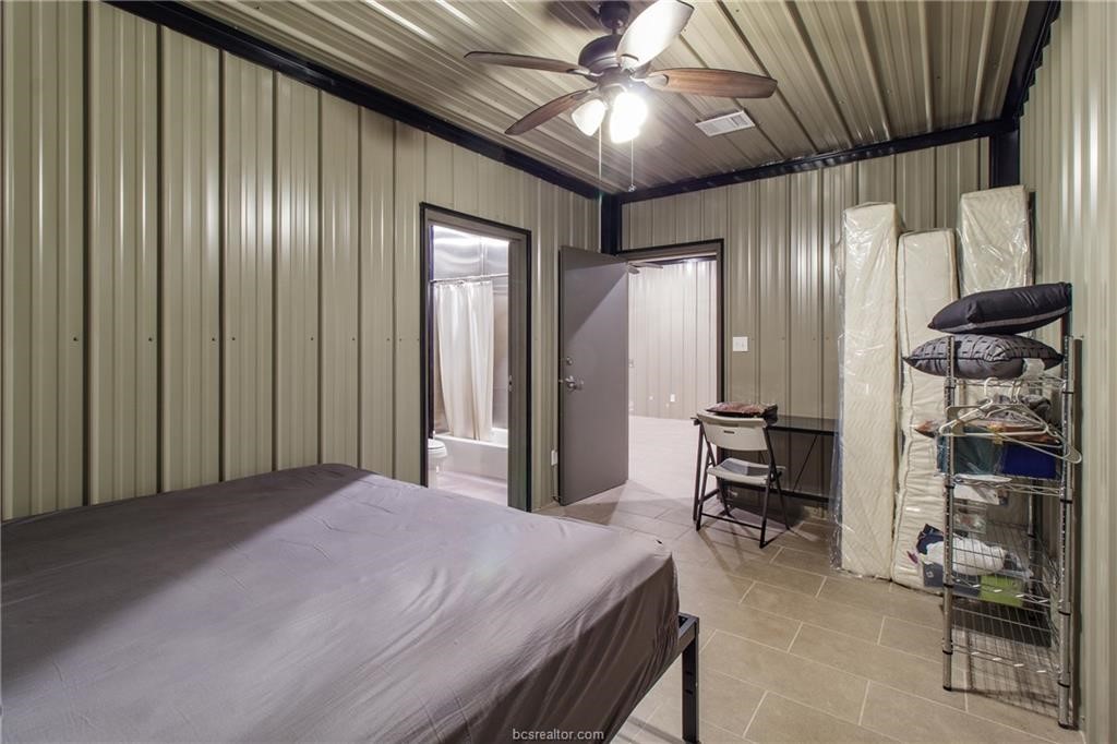 4558 Hicks Lane Bryan, TX 77845 - Photo 45 of 48 a bedroom with a bed and a chandelier