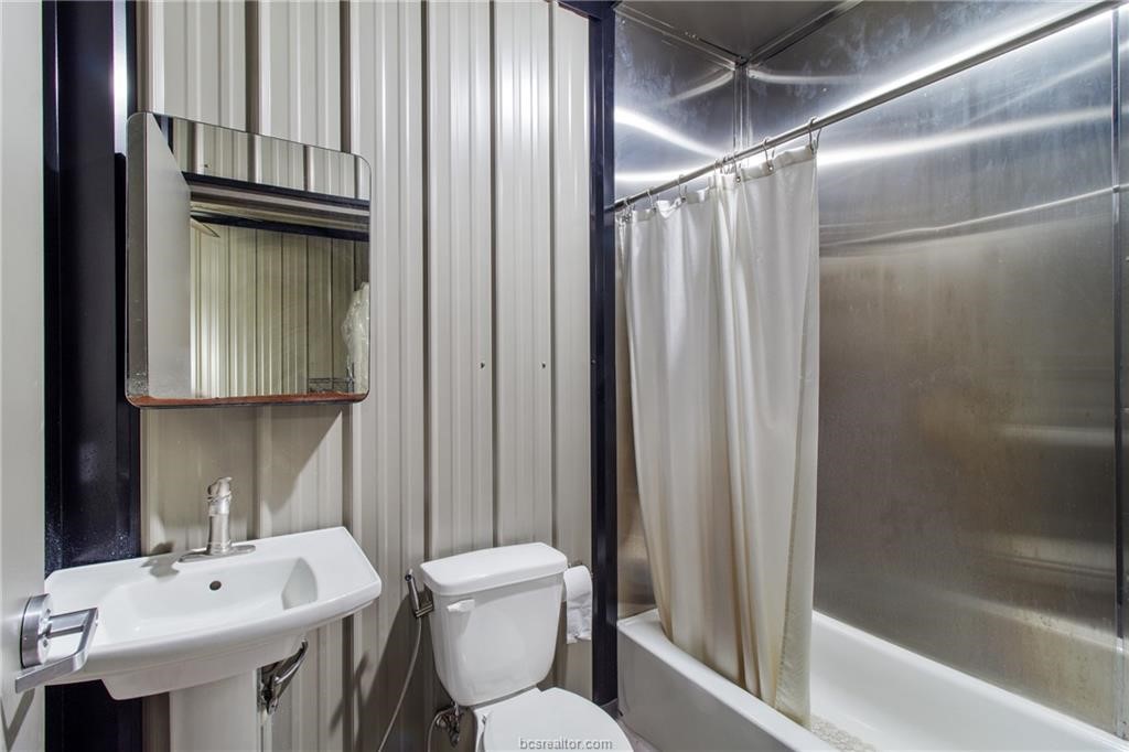 4558 Hicks Lane Bryan, TX 77845 - Photo 46 of 48 a bathroom with a sink a toilet and shower