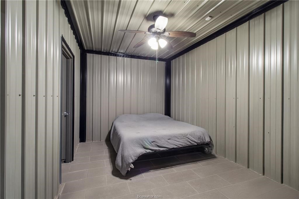 4558 Hicks Lane Bryan, TX 77845 - Photo 47 of 48 a bedroom with a bed and a chandelier