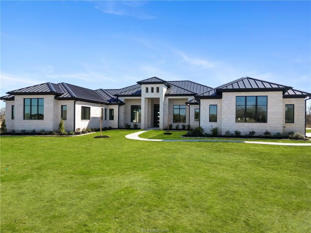 4558 Hicks Lane Bryan, TX 77845 - Photo 5 of 48 a front view of a house with a garden