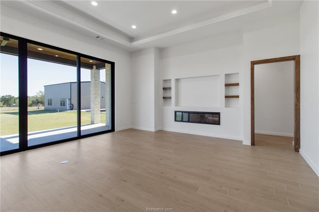 4558 Hicks Lane Bryan, TX 77845 - Photo 7 of 48 a view of an empty room with a fireplace and a window