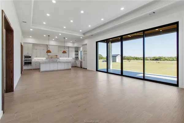 a view of a kitchen with large windows