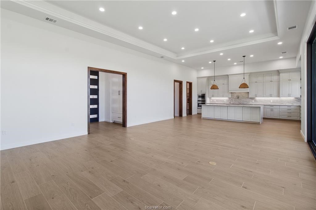 4558 Hicks Lane Bryan, TX 77845 - Photo 9 of 48 a large kitchen with a large counter top stainless steel appliances and cabinets