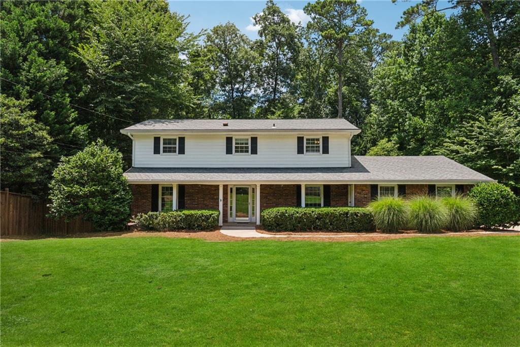 4984 Wickford Way Atlanta, GA 30338 - Photo 1 of 1 a front view of a house with a garden