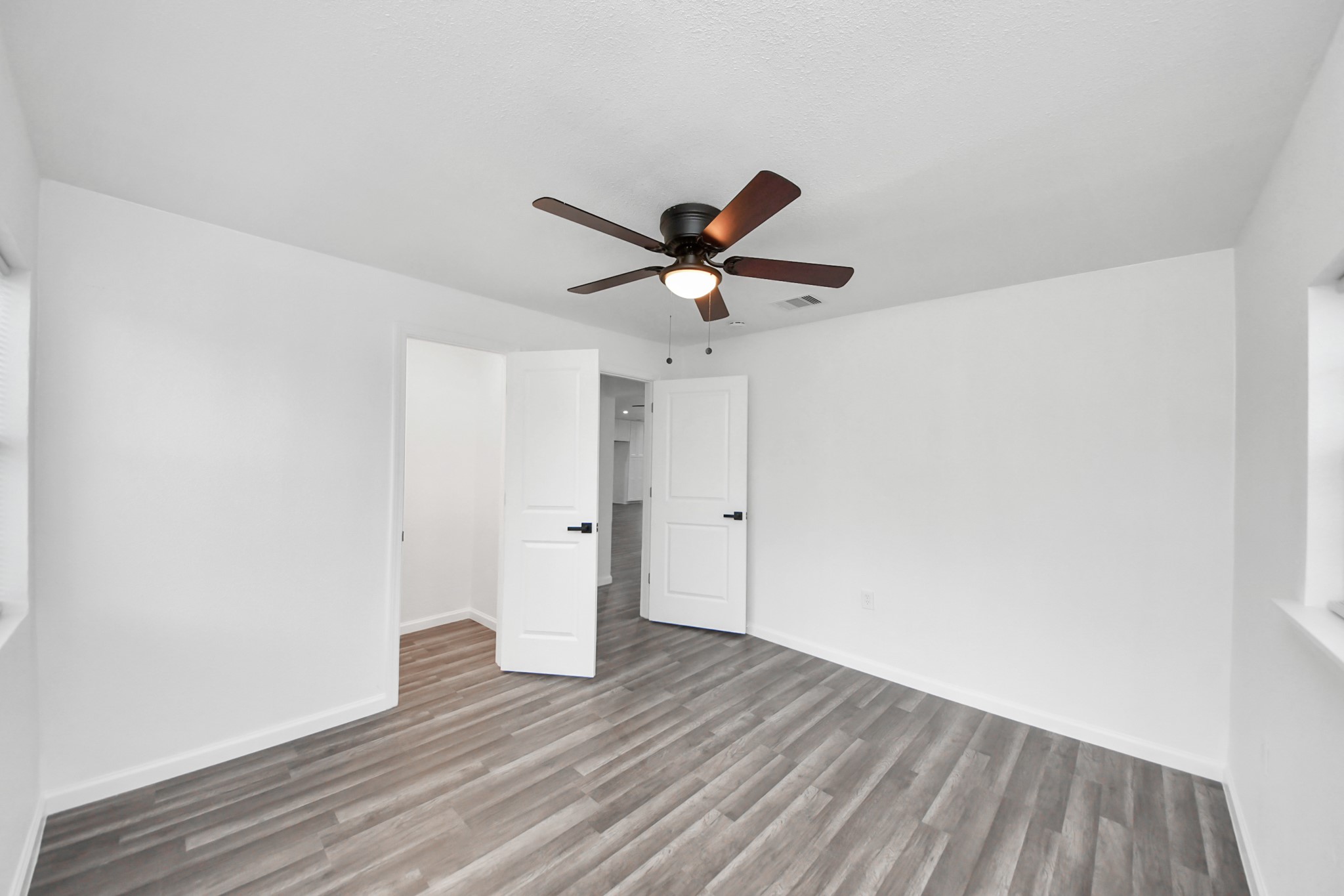 207 East Defee Avenue Baytown, TX 77520 - Photo 28 of 36 a view of an empty room with wooden floor