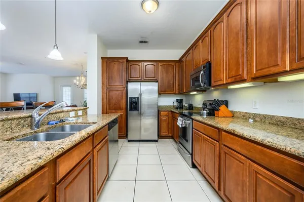 a kitchen with stainless steel appliances granite countertop a sink counter space cabinets and a large window