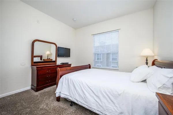 a bedroom with a bed and a television