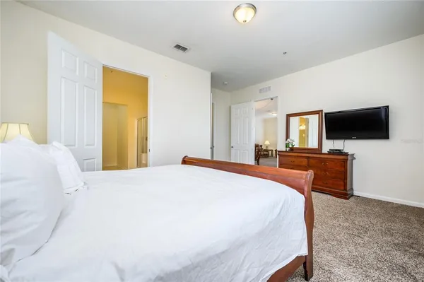 a bedroom with a bed and a flat screen tv