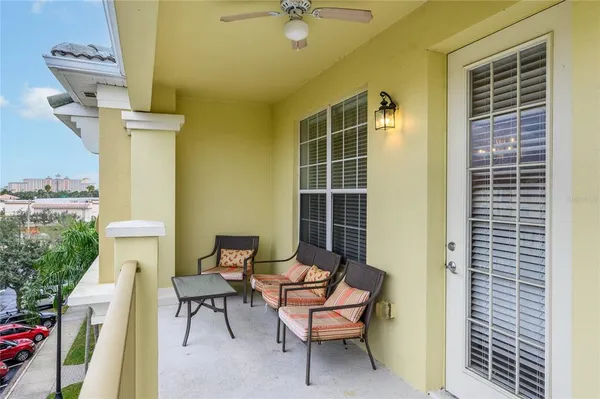 a balcony with table and chairs
