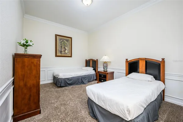 a bedroom with double bed and a potted plant
