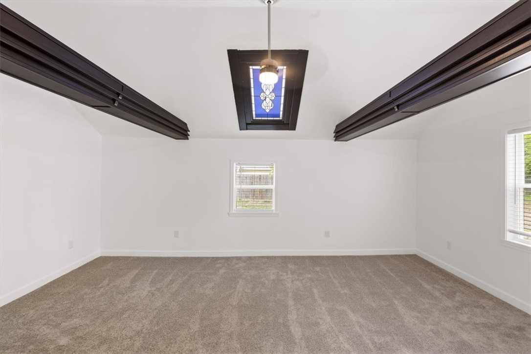 629 Little Meadow Drive Riverside, OH 45404 - Photo 33 of 48 This airy room features plush carpeting and unique architectural beams, creating an inviting atmosphere.