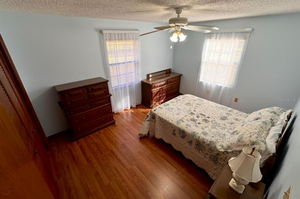 5912 Bailey Road Plant City, FL 33565 - Photo 16 of 30 a bedroom with a bed and a dresser