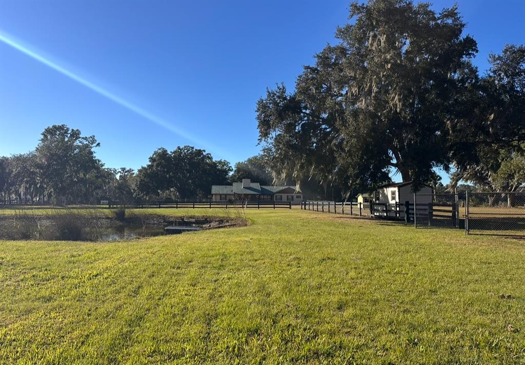 5912 Bailey Road Plant City, FL 33565 - Photo 21 of 30 a view of swimming pool with trees and a lake view