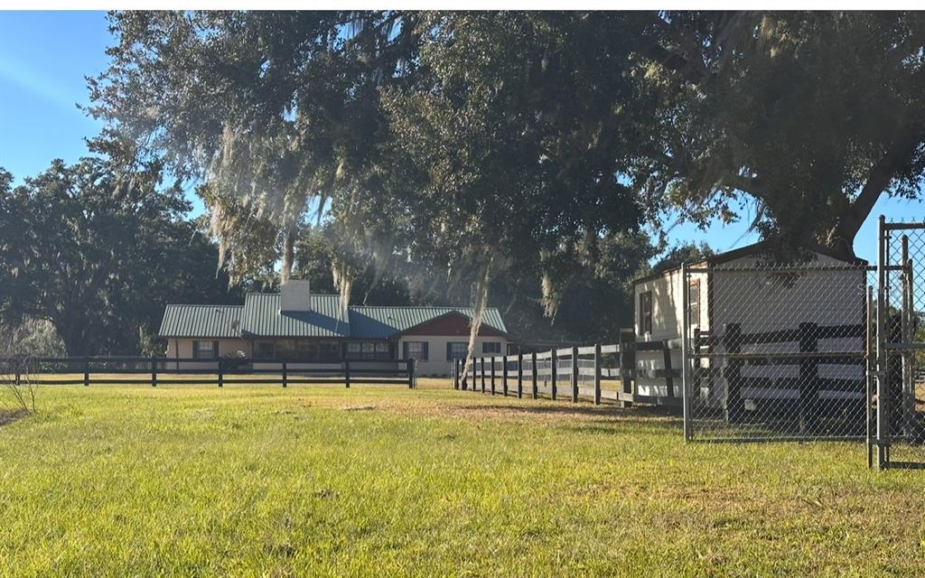 5912 Bailey Road Plant City, FL 33565 - Photo 25 of 30 a swimming pool that has lawn chairs with wooden fence