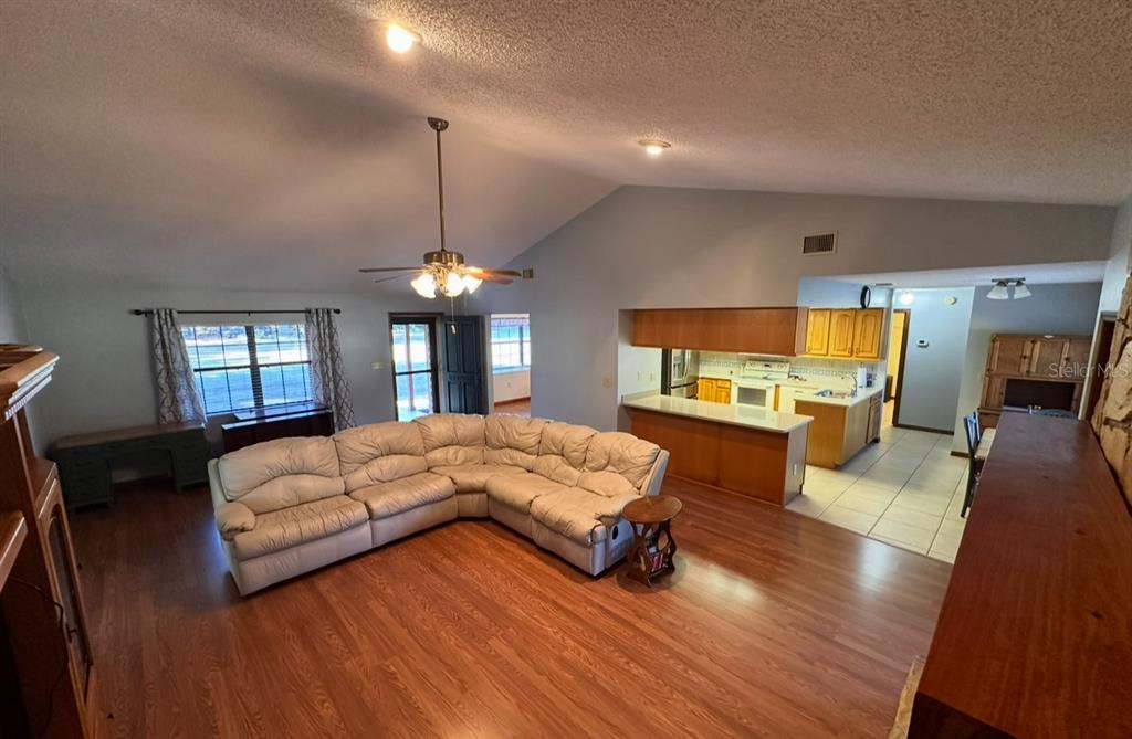 5912 Bailey Road Plant City, FL 33565 - Photo 6 of 30 a spacious bedroom with a large bed and a chandelier