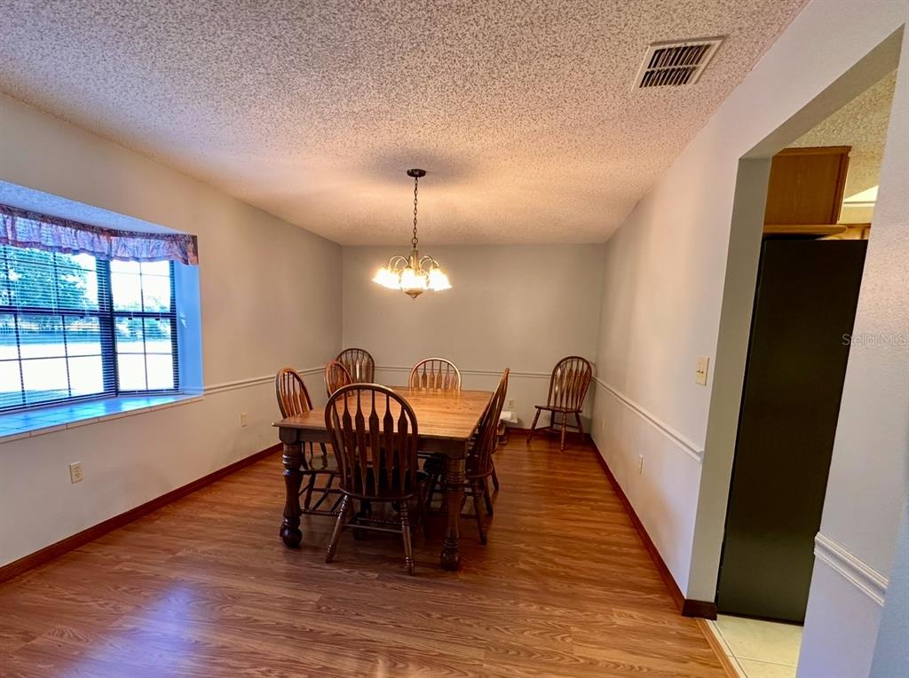 5912 Bailey Road Plant City, FL 33565 - Photo 10 of 30 a view of a dining room with furniture window and wooden floor