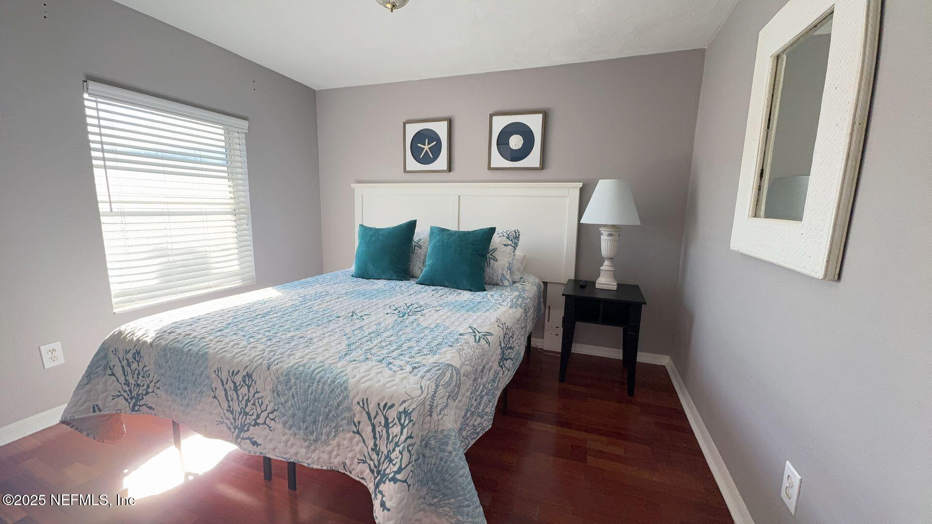 108 South 5th Street, Unit 4D Flagler Beach, FL 32136 - Photo 11 of 20 a bedroom with a bed and a window