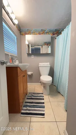 a bathroom with a toilet a sink and a shower