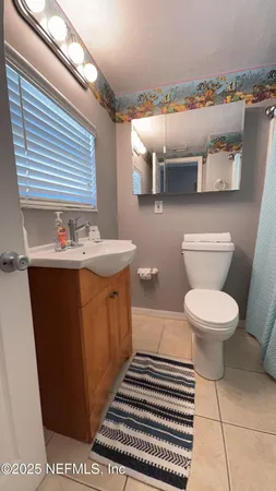 a bathroom with a sink a toilet and mirror
