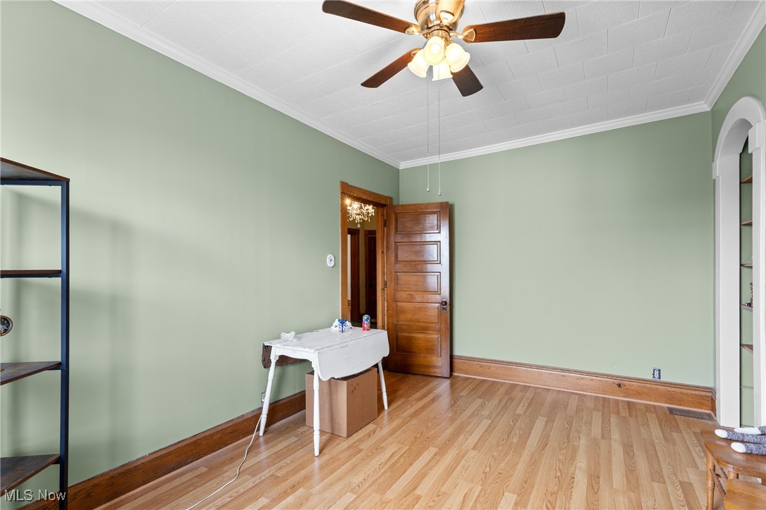 1011 Parriott Avenue Moundsville, WV 26041 - Photo 27 of 44 Unfurnished office with ornamental molding, light wood-style floors, and ceiling fan