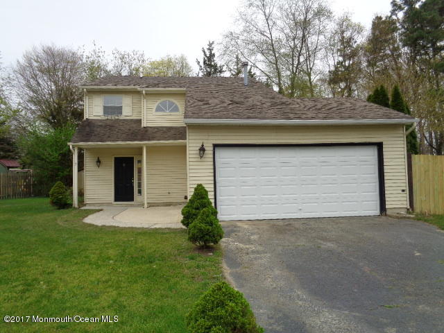 7 Sweet Gum Road Howell, NJ 07731 - Photo 1 of 30 a front view of a house with a garden and yard