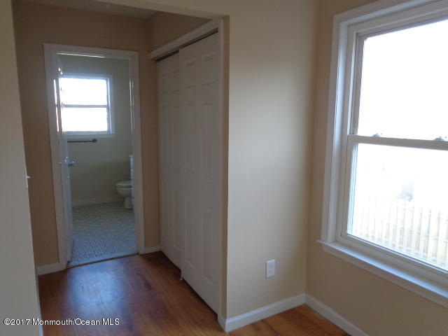 7 Sweet Gum Road Howell, NJ 07731 - Photo 11 of 30 a view of an empty room with a window and wooden floor