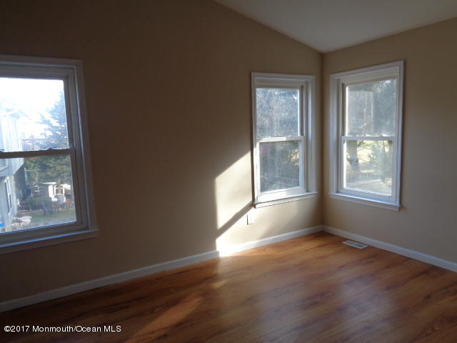 7 Sweet Gum Road Howell, NJ 07731 - Photo 12 of 30 a view of an empty room with wooden floor and a window