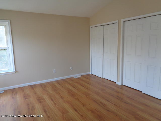 7 Sweet Gum Road Howell, NJ 07731 - Photo 13 of 30 a view of an empty room with wooden floor and a window