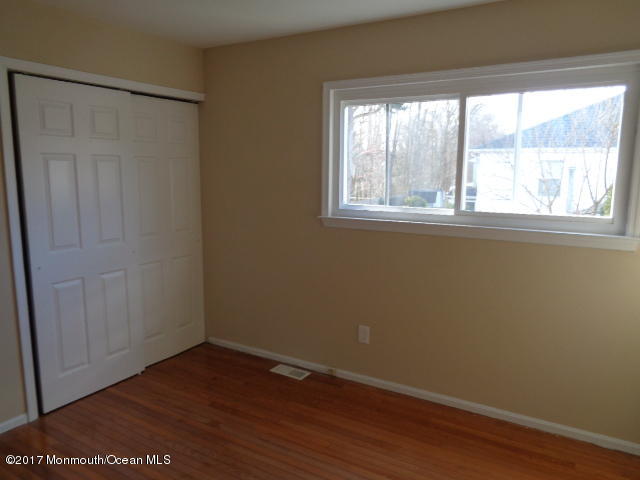 7 Sweet Gum Road Howell, NJ 07731 - Photo 14 of 30 an empty room with wooden floor and windows