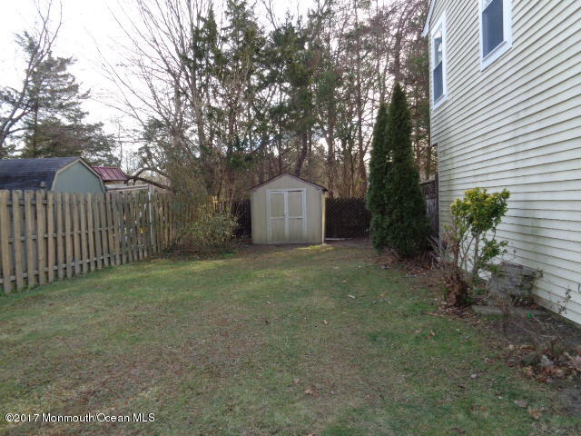 7 Sweet Gum Road Howell, NJ 07731 - Photo 18 of 30 a wooden house with trees in front of it
