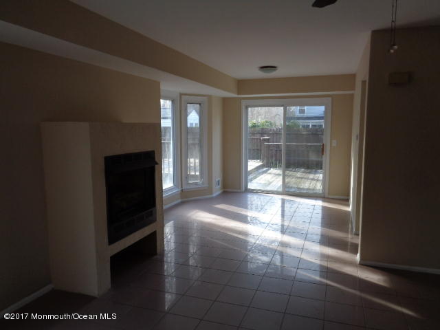 7 Sweet Gum Road Howell, NJ 07731 - Photo 3 of 30 a view of a hallway with wooden floor and a fireplace