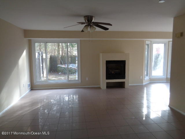 7 Sweet Gum Road Howell, NJ 07731 - Photo 4 of 30 a view of a livingroom with a fireplace window and a ceiling fan