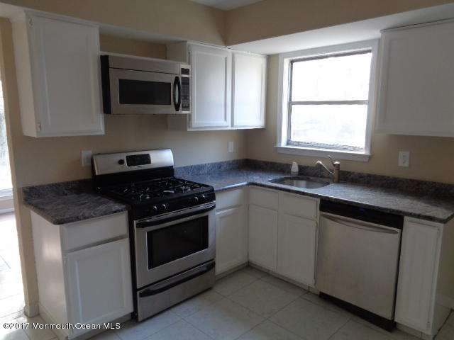 7 Sweet Gum Road Howell, NJ 07731 - Photo 5 of 30 a kitchen with granite countertop a sink stove and microwave
