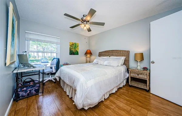 a bedroom with a bed and a chandelier