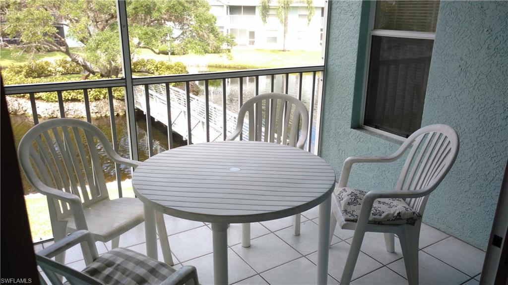 137 Wading Bird Circle, Unit F206 Naples, FL 34110 - Photo 9 of 11 a view of a balcony with chair and table