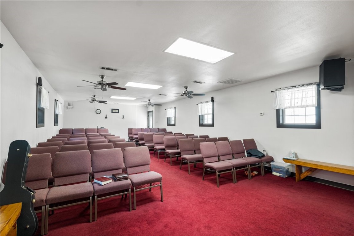 2606 Santa Rosa Street Austin, TX 78702 - Photo 12 of 28 Carpeted home theater room featuring plenty of natural light and ceiling fan