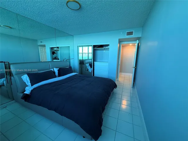 a bed room with a bed and mirror