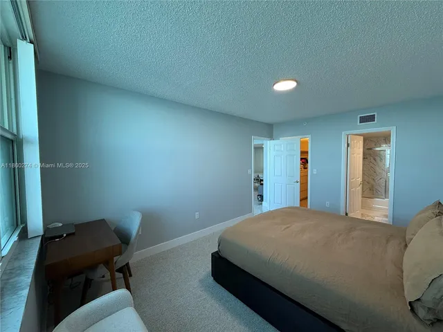 a bedroom with a bed and furniture