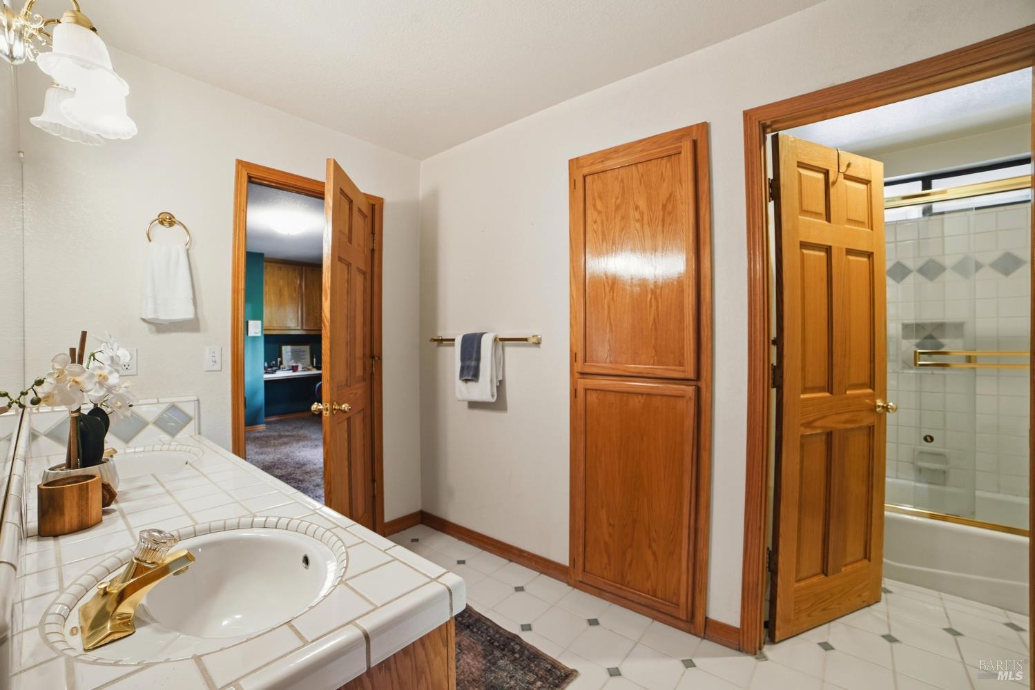 4818 Kieran Court Santa Rosa, CA 95405 - Photo 43 of 51 a en suite bathroom with a granite countertop sink and a mirror