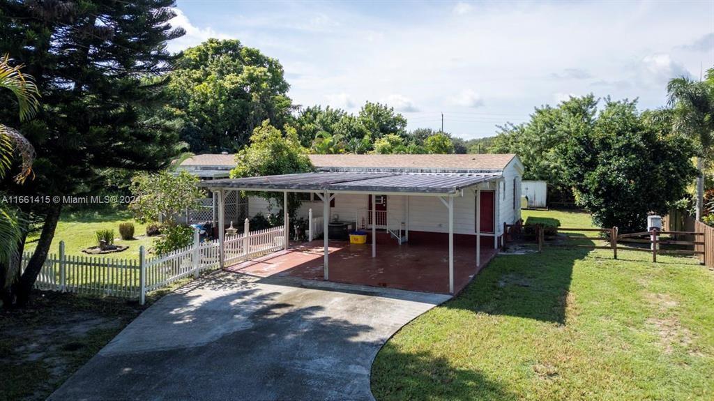 a view of a house with a yard patio and slide