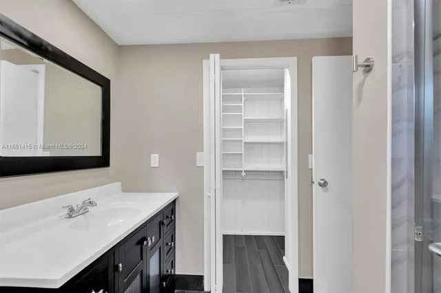 a bathroom with a sink double vanity and a mirror
