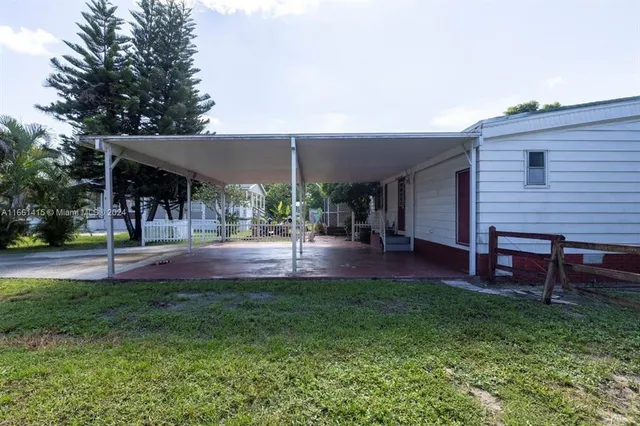 a view of a patio with table and chairs under an umbrella