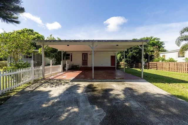 a view of a patio with table and chairs with wooden fence