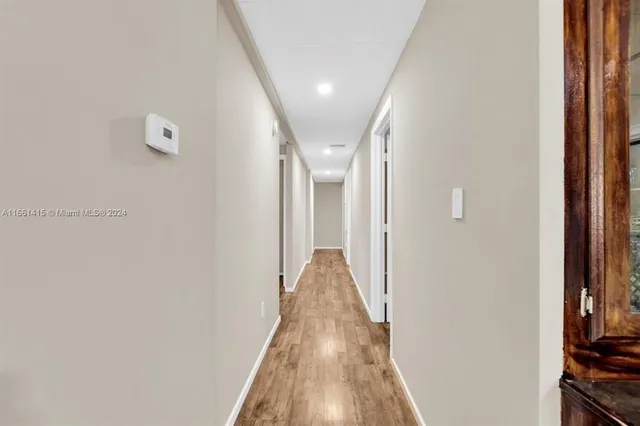 a view of hallway with wooden floor