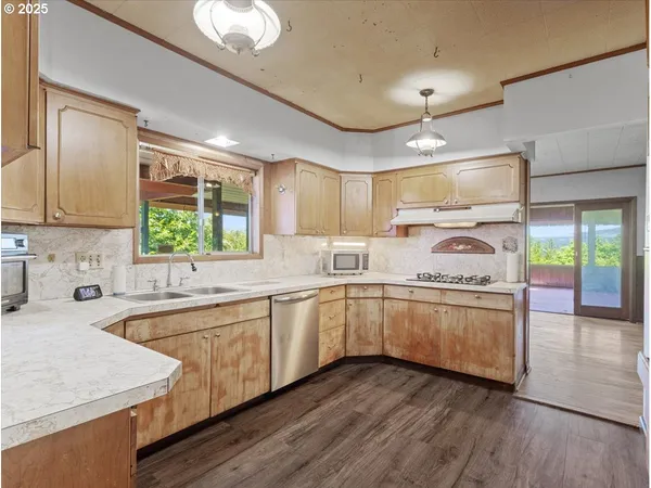 a kitchen with granite countertop a sink stainless steel appliances and cabinets