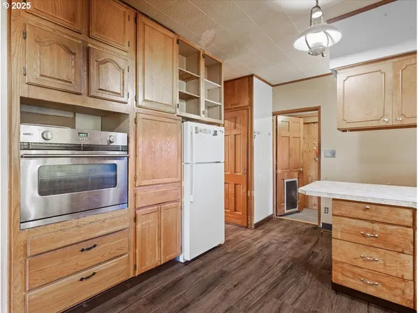 a kitchen with stainless steel appliances granite countertop cabinets and wooden floor